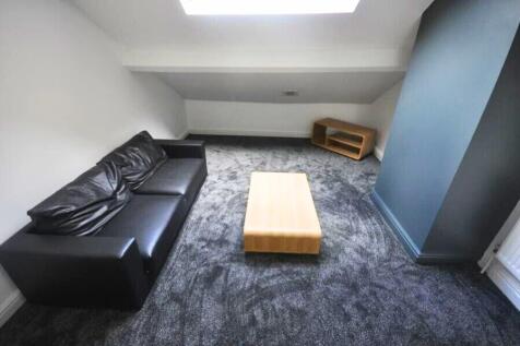 Contemporary living room featuring a sleek blac...