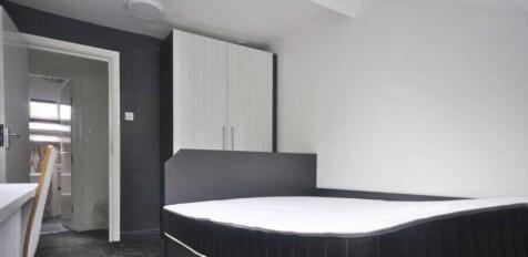 A clean and modern double bedroom featuring a c...