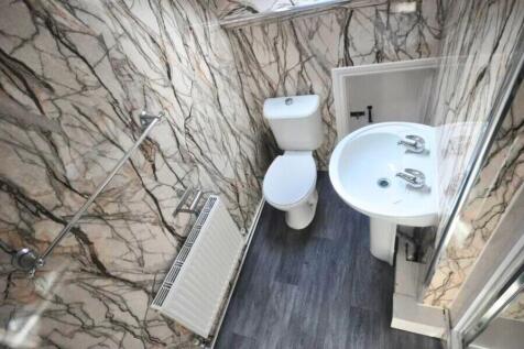 Bright and tidy small toilet room featuring mod...