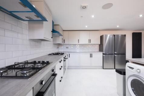 A modern kitchen featuring sleek cabinetry, hig...