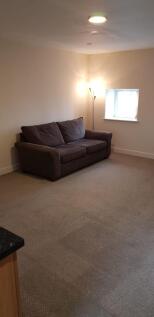 A neat and comfortable living room featuring a ...