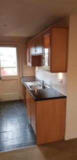 A neat and functional kitchen featuring wooden ...