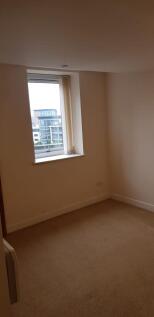 A simple, clean room with a large window allowi...