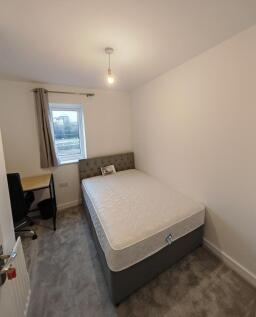 A neat and modern double bedroom featuring a co...