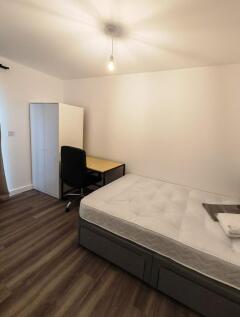 A neat and simple single bedroom featuring a co...