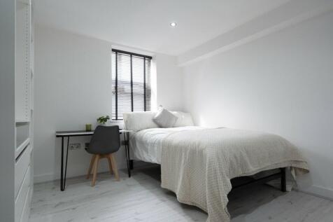 A bright and inviting double bedroom featuring ...