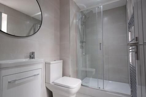 A modern and clean bathroom with a stylish show...