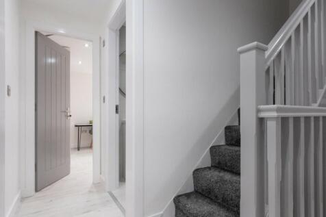 A modern and well-maintained hallway leading to...