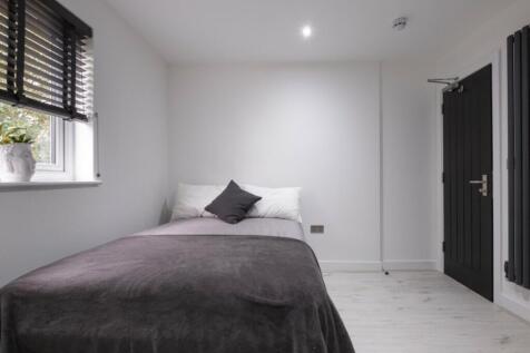 This cozy double bedroom features a comfortable...