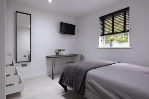 A stylish double bedroom featuring a comfortabl...