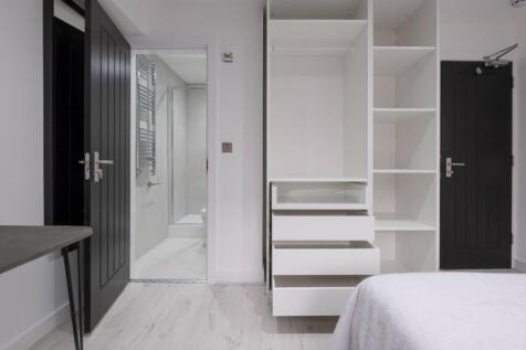 This inviting double bedroom features sleek mod...