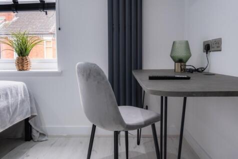 Bright and cozy double bedroom featuring a styl...