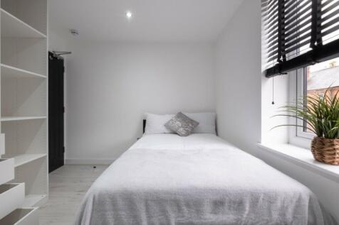 Bright and cozy double bedroom featuring a comf...