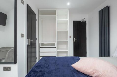 This stylish double bedroom features a spacious...