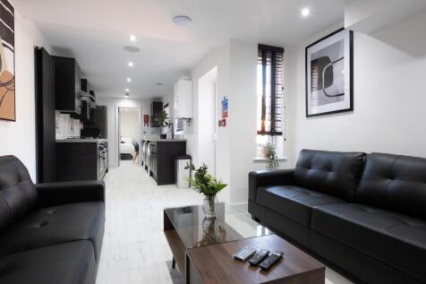 Bright and modern living room featuring sleek b...