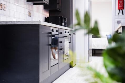 Modern kitchen featuring sleek cabinetry and am...