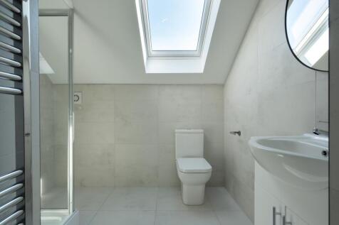 Modern bathroom featuring sleek design with nat...