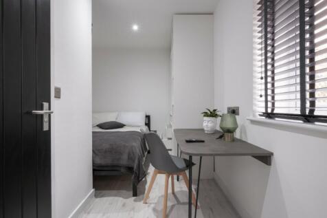 This stylish double bedroom features a cozy amb...