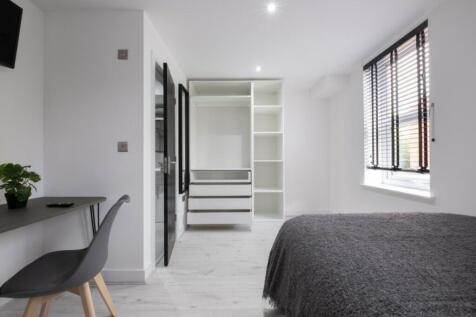 A stylish and spacious double bedroom featuring...
