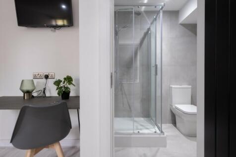Modern bathroom suite featuring a sleek shower,...