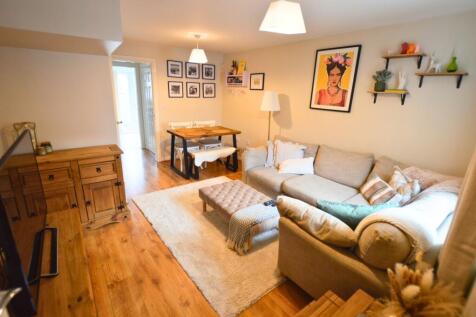 A warm and inviting living room featuring a lar...