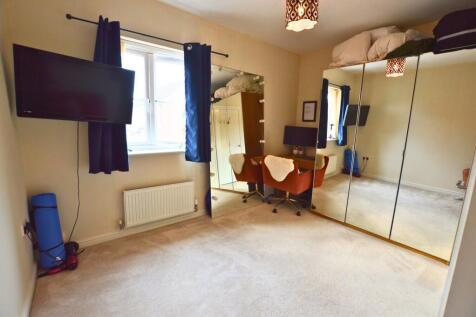 A bright and tidy double bedroom featuring a la...