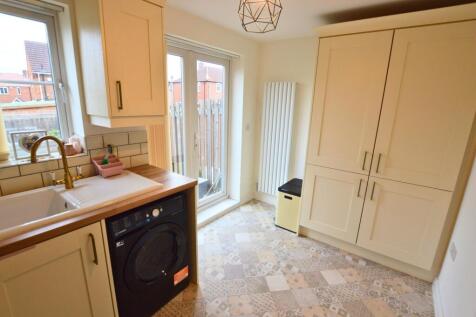 Bright and modern kitchen featuring patterned t...