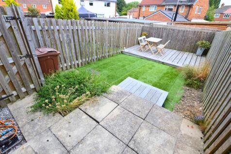 A charming, well-maintained garden space featur...