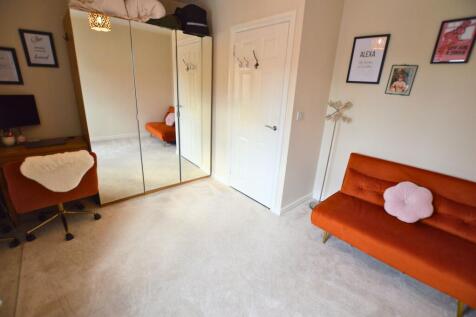 A bright and tidy double bedroom featuring a wa...