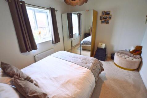 Bright and cozy double bedroom featuring a comf...