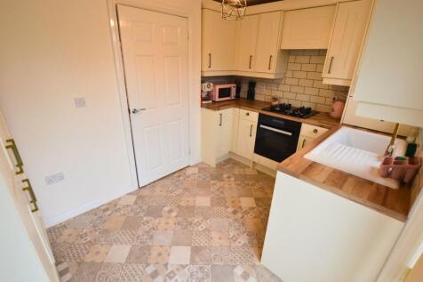 A bright, well-maintained kitchen featuring sty...