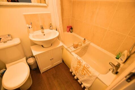 A well-maintained bathroom featuring a full bat...