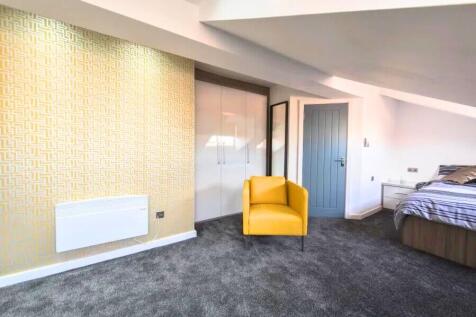 Bright and spacious master bedroom featuring a ...
