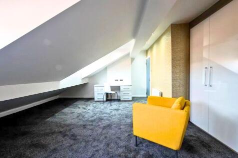 A spacious and bright attic master bedroom feat...