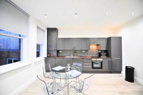 Modern kitchen with sleek grey cabinets and bui...