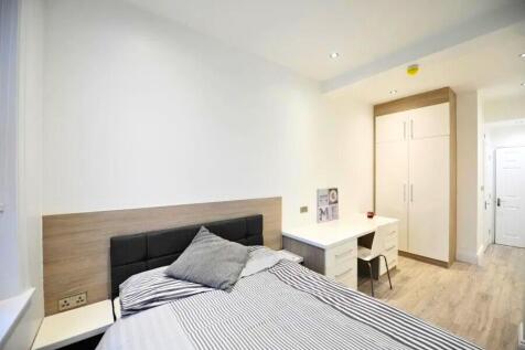 Bright and modern single bedroom featuring a co...