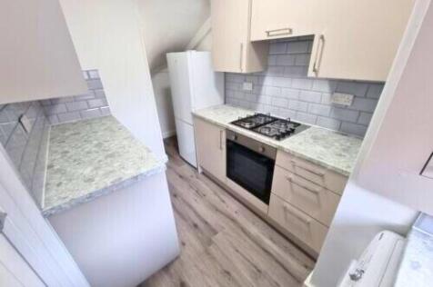 Bright and tidy kitchen with modern cabinetry, ...