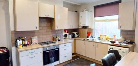 Bright and modern kitchen featuring ample cabin...