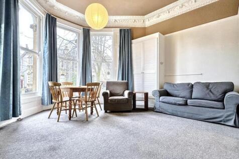 A bright and inviting living room featuring lar...