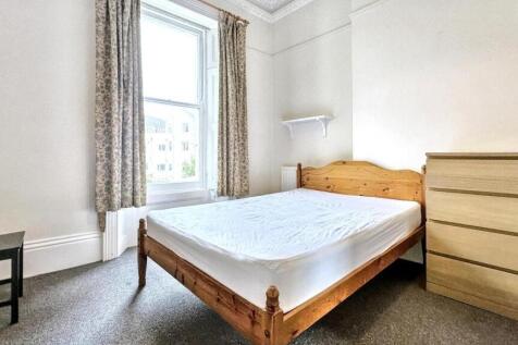 Bright and airy double bedroom featuring a wood...