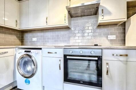 Modern kitchen with integrated oven and electri...