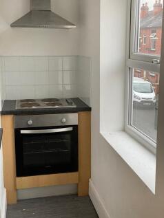 Compact kitchen area featuring a modern electri...