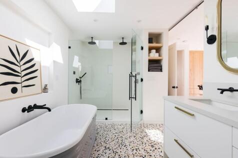 A modern and clean bathroom featuring a bath an...