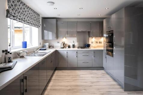 A modern and clean kitchen with sleek grey cabi...