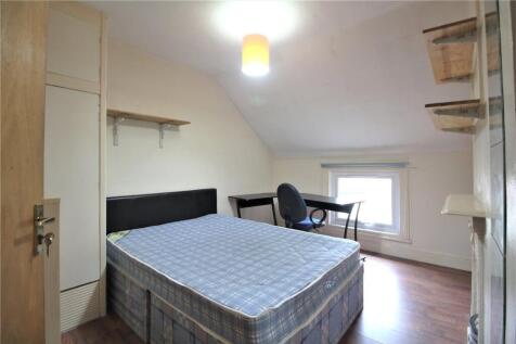 A bright and tidy master bedroom featuring a do...