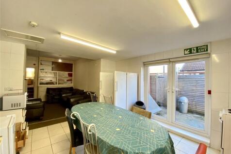A bright kitchen featuring a dining table cover...