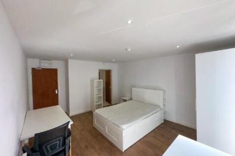 Bright and spacious master bedroom featuring a ...