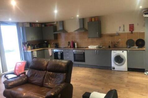 Spacious modern kitchen area with sleek grey ca...