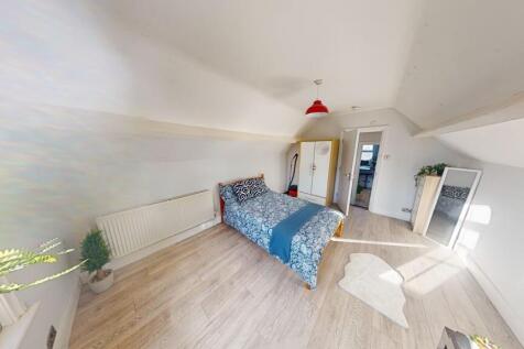Bright and spacious master bedroom featuring a ...