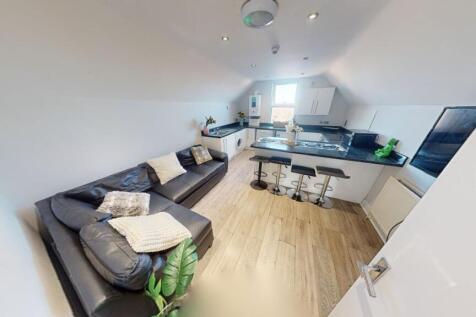 A stylish and contemporary living room featurin...